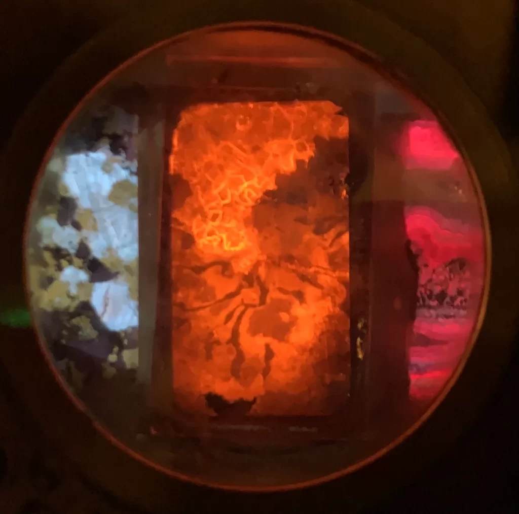 three rock samples simultaneously displaying luminescence upon bombardment of a de-focused electron beam